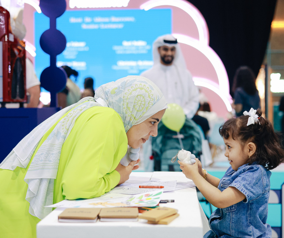 A mother and daughter playing together at Baby Expo Riyadh.